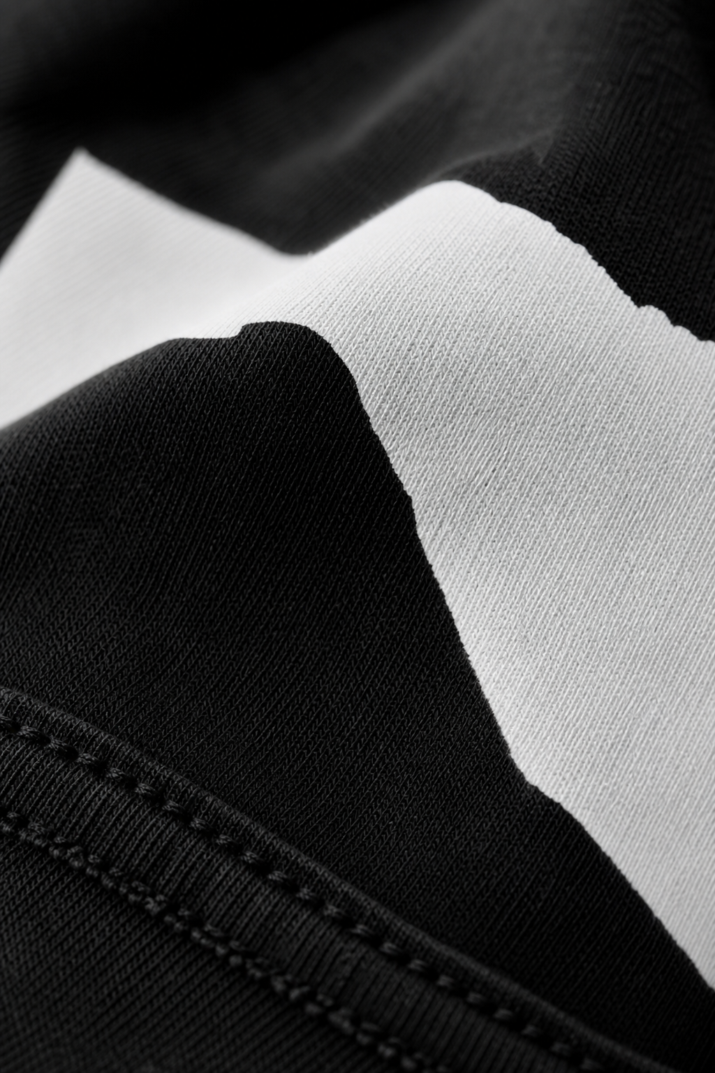 Macro close-up shot of high-definition printed brand logo on 240 GSM cotton fabric