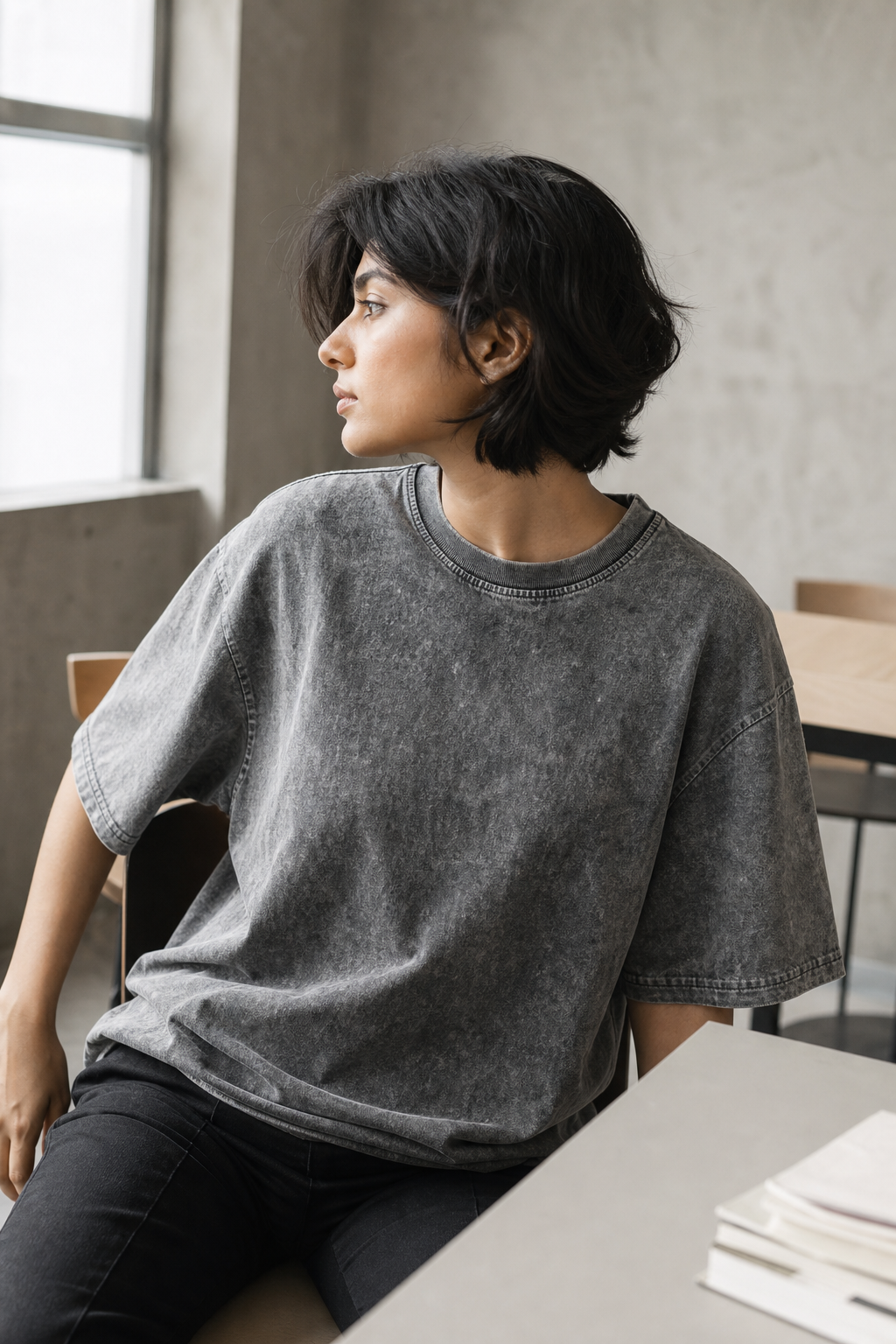 Model wearing personalized acid wash oversized t-shirt in outdoor urban setting