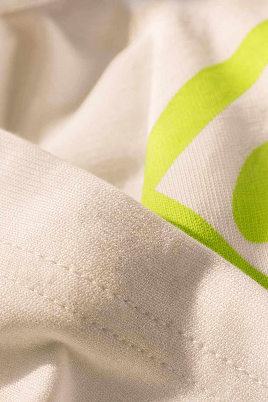 Close up texture detail of 240 GSM combed cotton fabric and crisp print quality